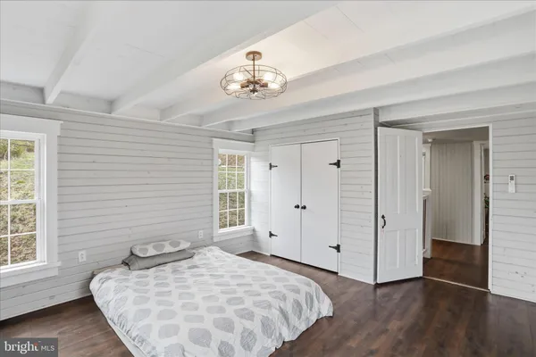 a view of a room with wooden floor and windows