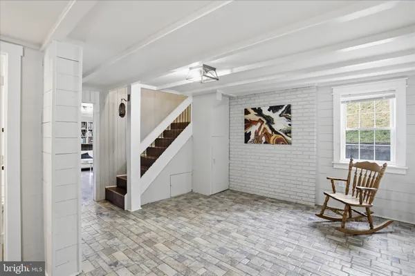 a workspace with wooden floor and windows