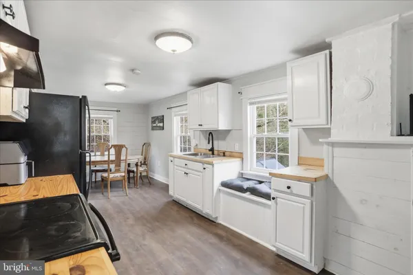 a kitchen with stainless steel appliances granite countertop a refrigerator stove microwave and sink
