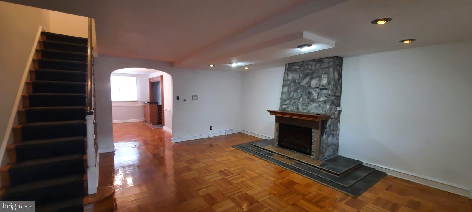 wooden floor in an empty room with a fireplace