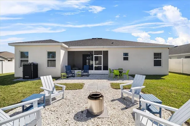 a view of a patio with dining table and chairs with wooden floor and fence
