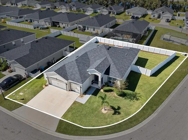 an aerial view of residential houses with outdoor space