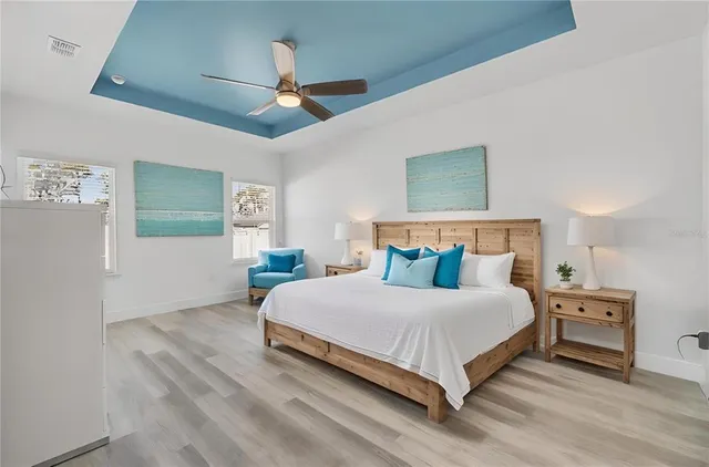 a bedroom with a bed and a ceiling fan