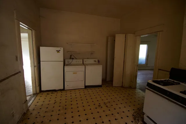 a kitchen with a refrigerator and a stove