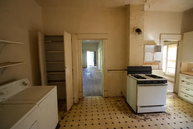 a kitchen with a refrigerator and a stove
