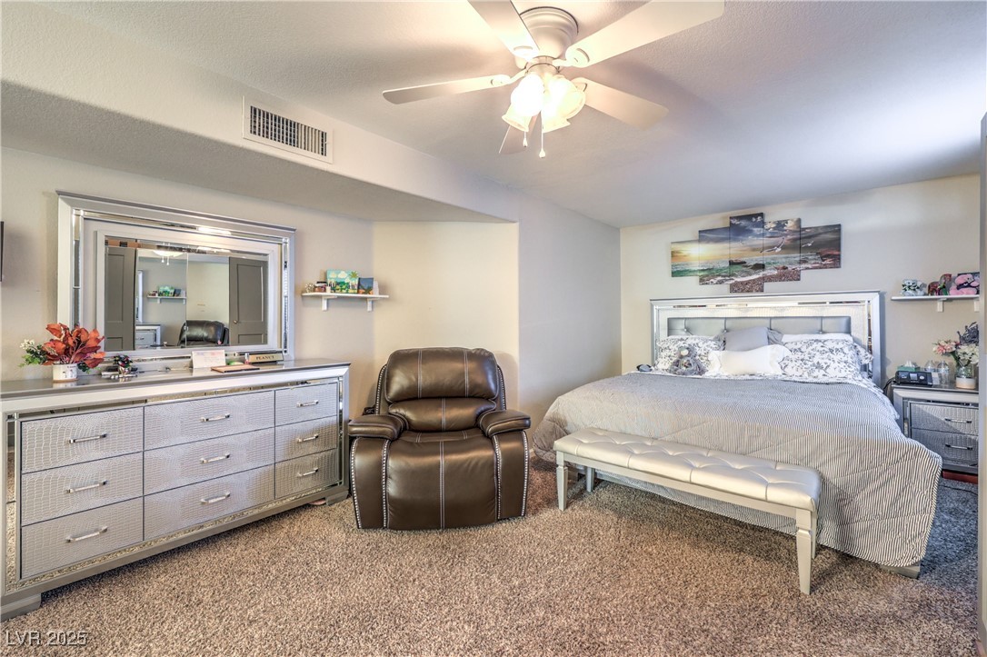 8056 Cimarron Ridge Drive, Unit 101 Las Vegas, NV 89128 - Photo 16 of 31 Bedroom featuring light carpet and ceiling fan
