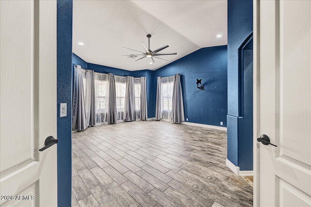 7624 North Citrus Road Waddell, AZ 85355 - Photo 21 of 57 a view of a hallway with a chandelier