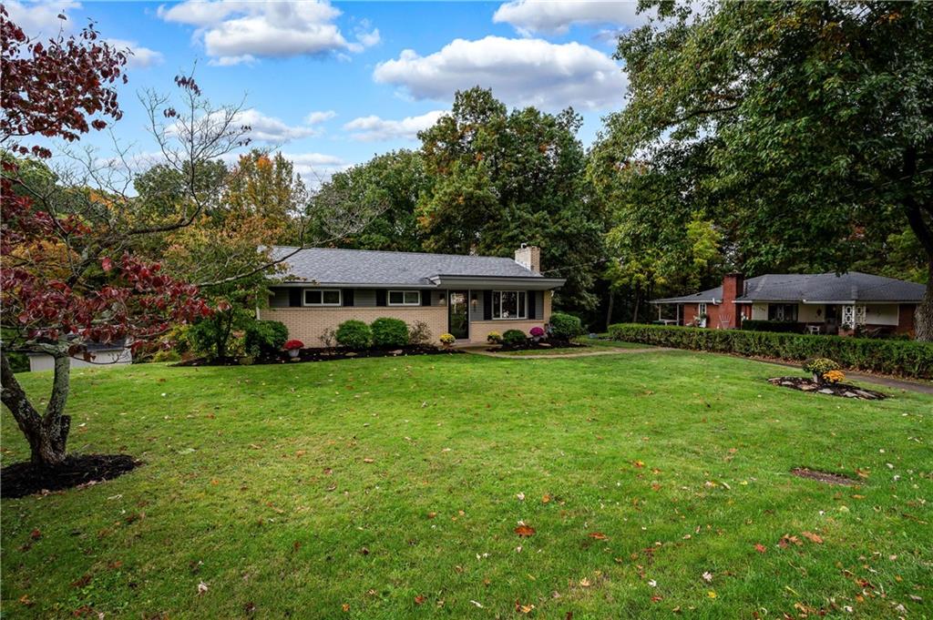 a view of a house with backyard sitting area and garden