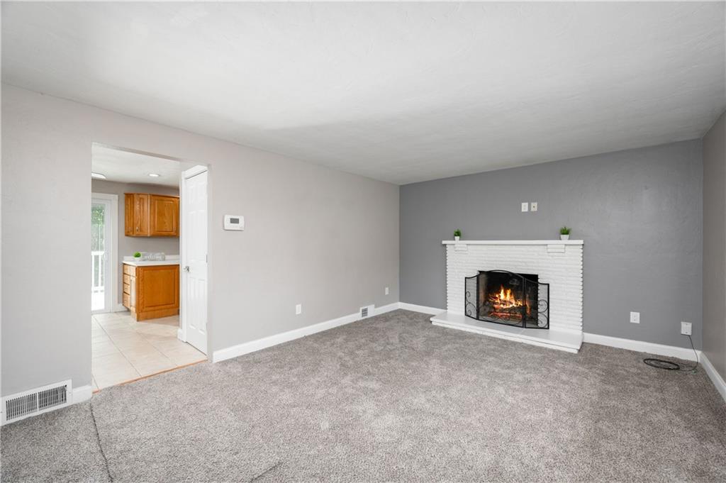 350 Limerick Road Wexford, PA 15090 - Photo 8 of 47 an empty room with a fireplace and painted walls