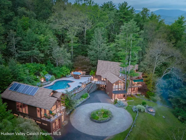 an aerial view of a house with garden space and street view