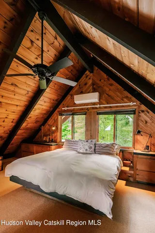 a bed sitting in a bedroom next to a window