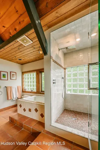 a view of a swimming pool and lounge chairs in patio