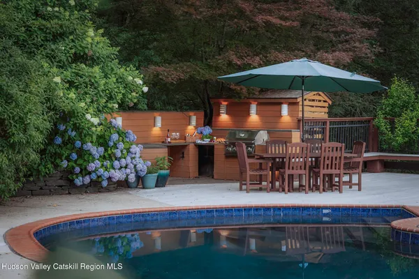 swimming pool view with a seating space