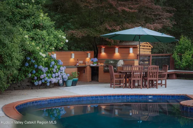 a backyard of a house with lots of green space and outdoor seating