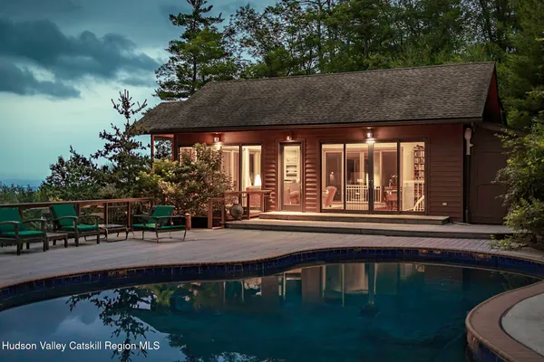 a backyard of a house with lots of green space and outdoor seating