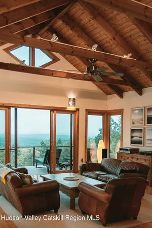 a living room with furniture and large windows