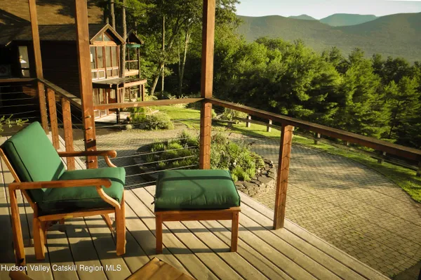 a view of a chairs and table on the balcony