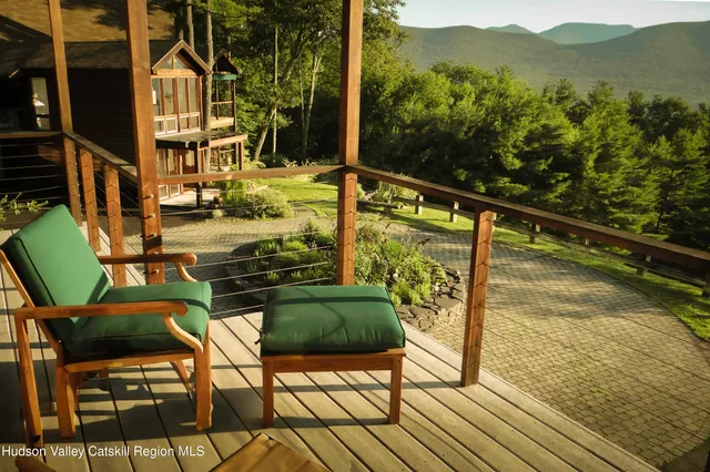 a living room with furniture flat screen tv and outdoor view