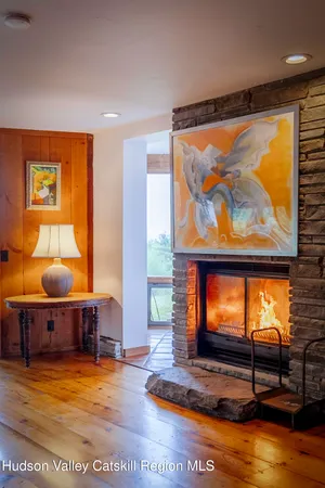 a living room with furniture flat screen tv and outdoor view