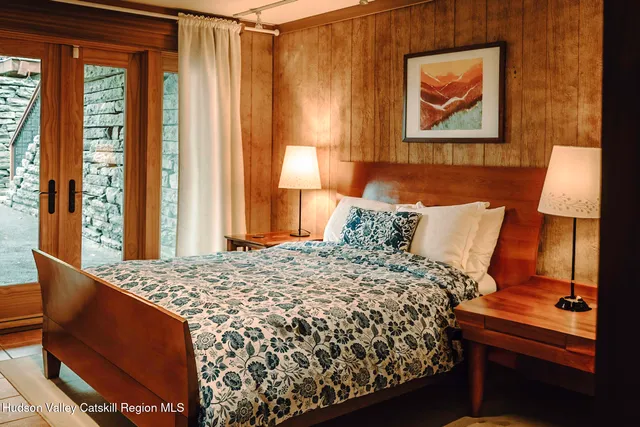 a bedroom with a large bed and a large window