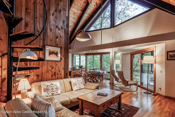 a living room with furniture a rug and a large window