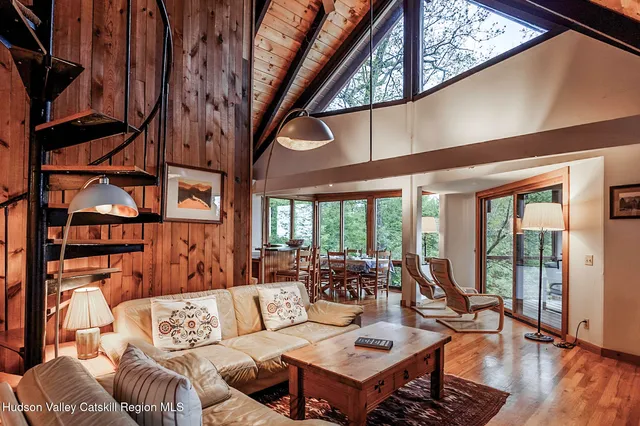 a living room with furniture a rug and a large window