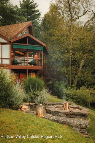 a view of house with outdoor space and sitting area