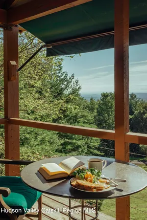 a view of a balcony with chair and table