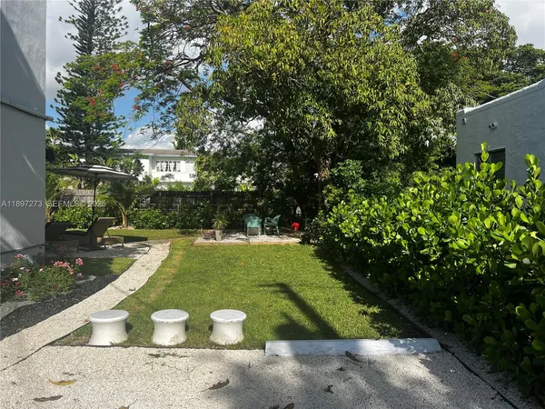 a view of a bench in the backyard