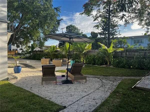 a view of a backyard with sitting area