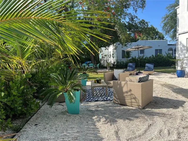 a kitchen with a sink and a stove top oven with wooden floor