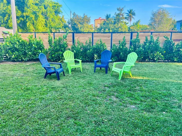 a spacious bedroom with a bed and a flat tv screen