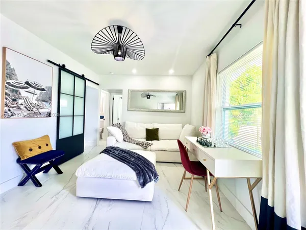 a bedroom with a bed and a large window