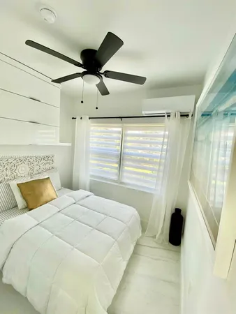 a bedroom with a bed and window