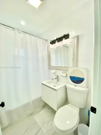 a bedroom with furniture and a large window