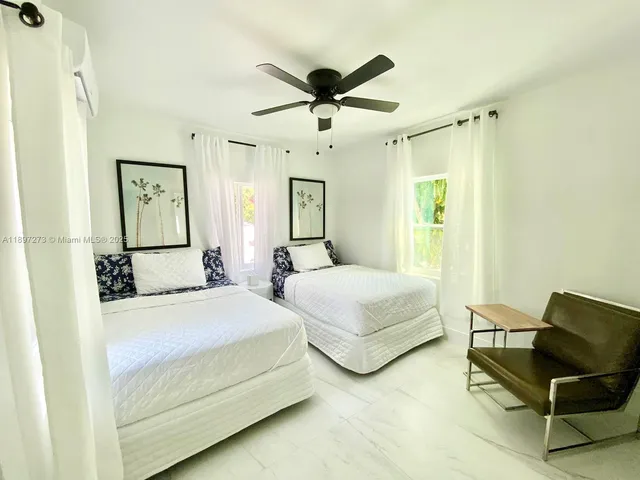 a bedroom with a bed and ceiling fan