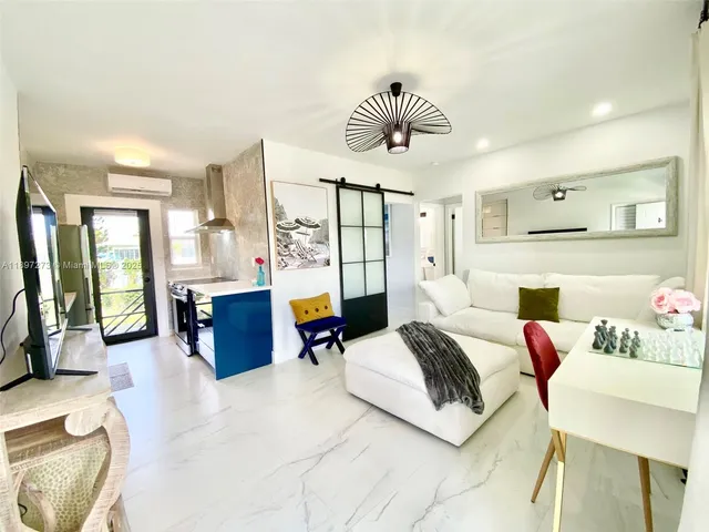 a bedroom with a bed and dresser with mirror