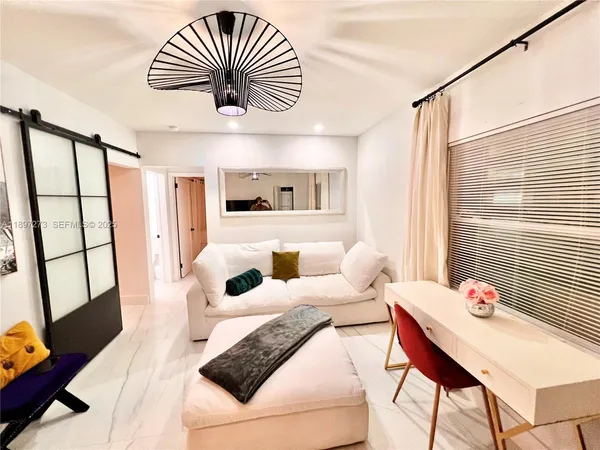 a living room with furniture and a chandelier