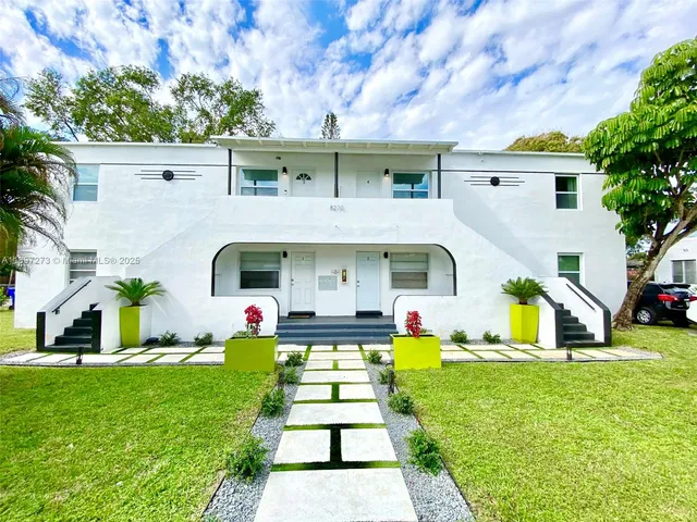 a view of a backyard with sitting area
