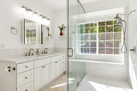 a bathroom with a tub sink vanity and a mirror