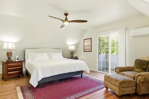 a bedroom with a bed a couch and a window