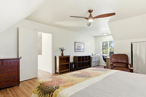 a bedroom with a bed dresser and a window