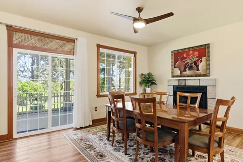 a dining room with furniture window and wooden floor