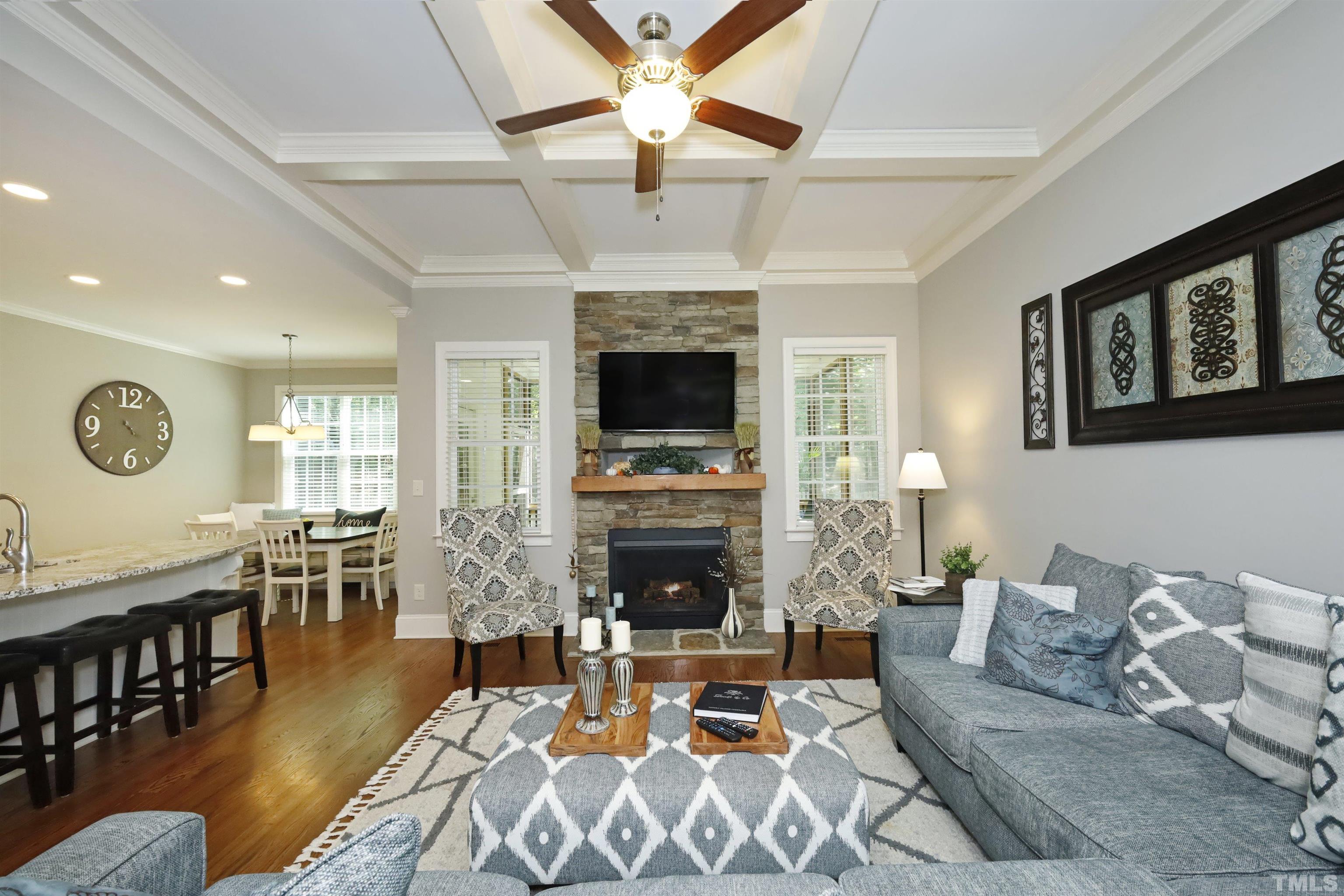 3630 Pine Needles Drive Wake Forest, NC 27587 - Photo 11 of 47 a living room with furniture a fireplace and a ceiling fan