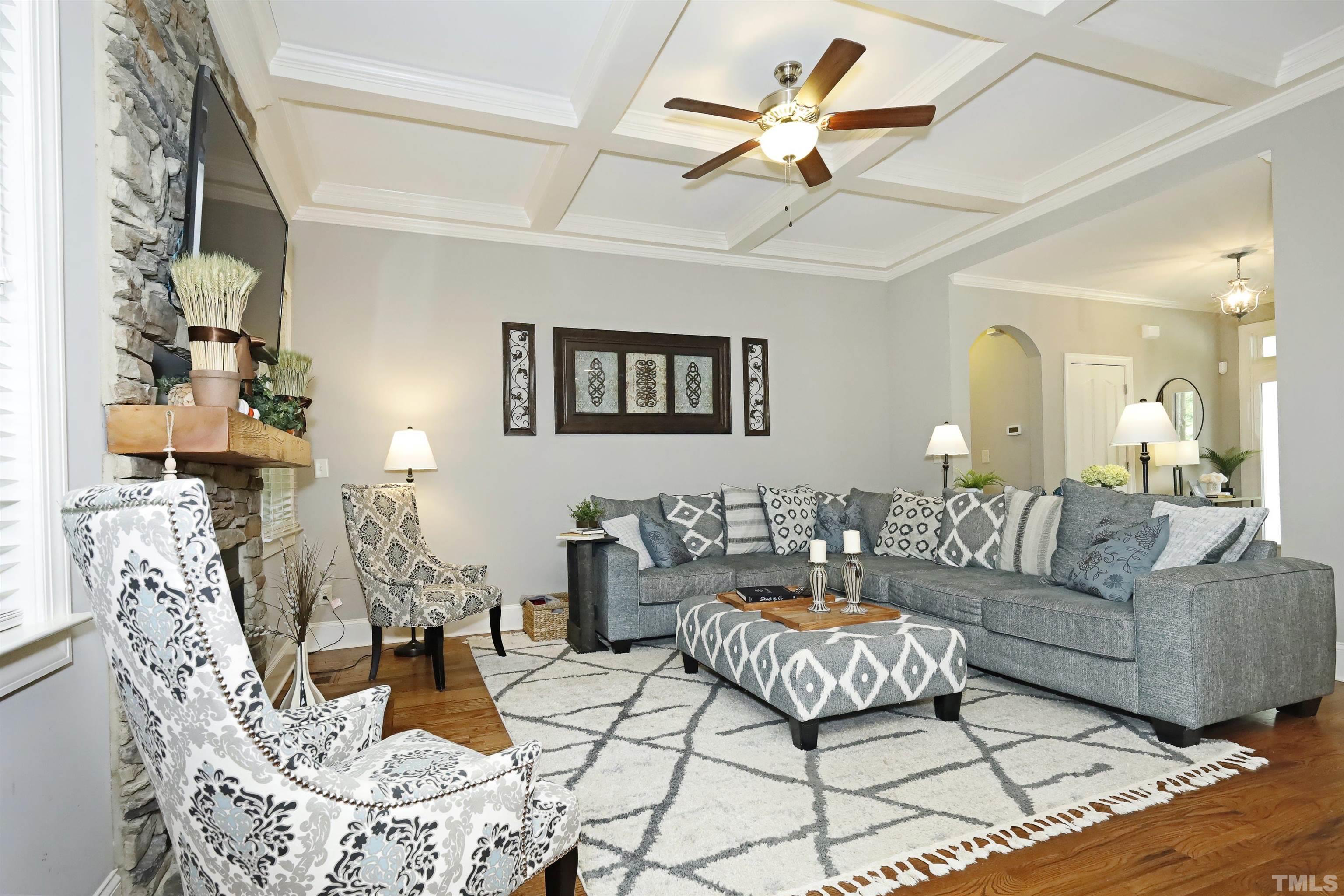 3630 Pine Needles Drive Wake Forest, NC 27587 - Photo 12 of 47 a living room with furniture a rug and a chandelier