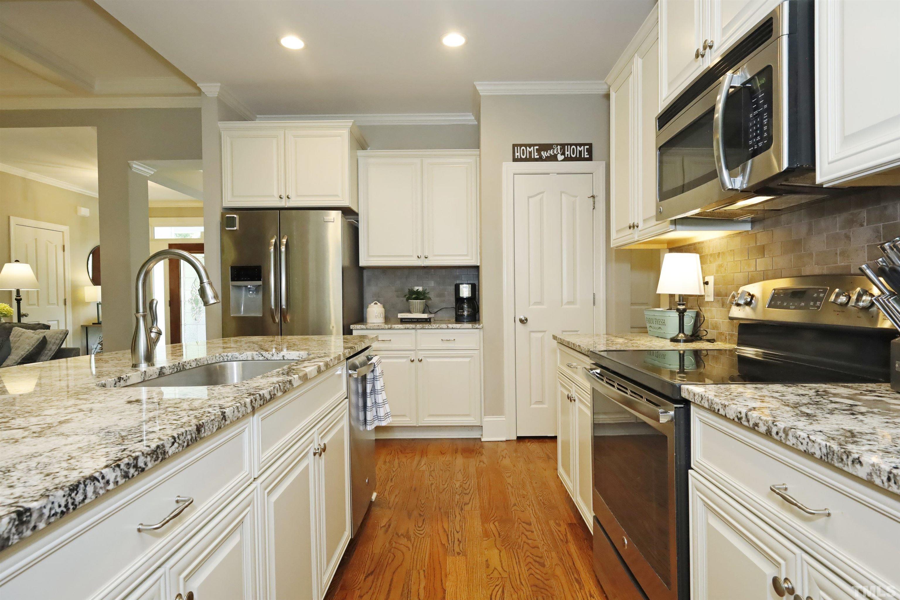 3630 Pine Needles Drive Wake Forest, NC 27587 - Photo 16 of 47 a kitchen with stainless steel appliances granite countertop a sink stove and refrigerator