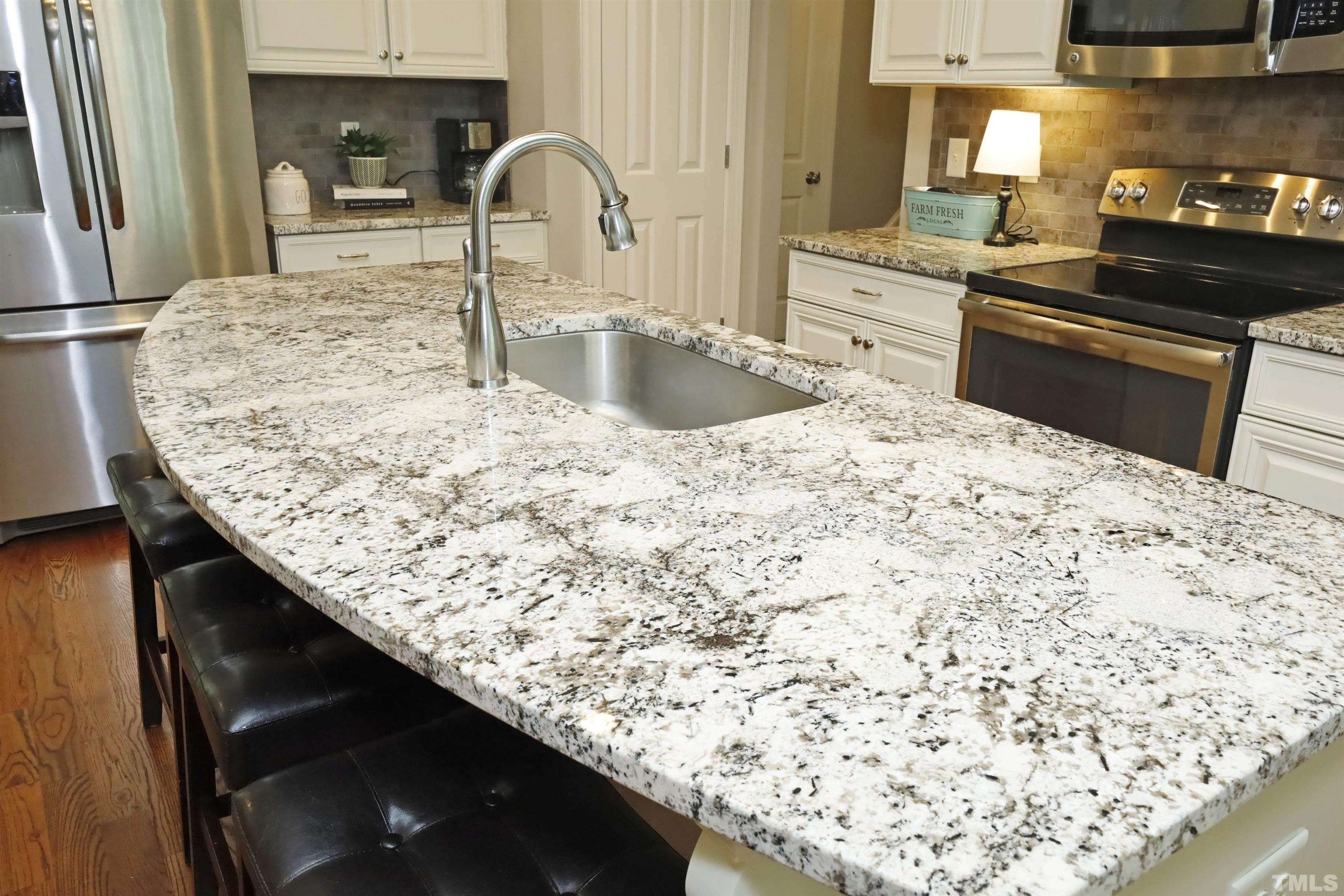 3630 Pine Needles Drive Wake Forest, NC 27587 - Photo 17 of 47 a kitchen with a sink and a refrigerator
