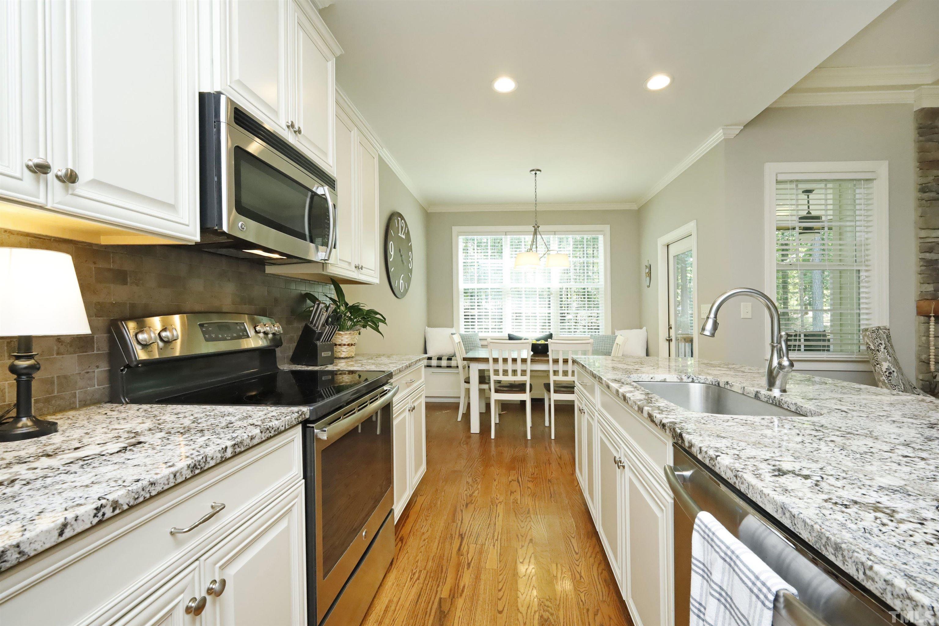 3630 Pine Needles Drive Wake Forest, NC 27587 - Photo 18 of 47 a kitchen with granite countertop lots of counter top space and stainless steel appliances