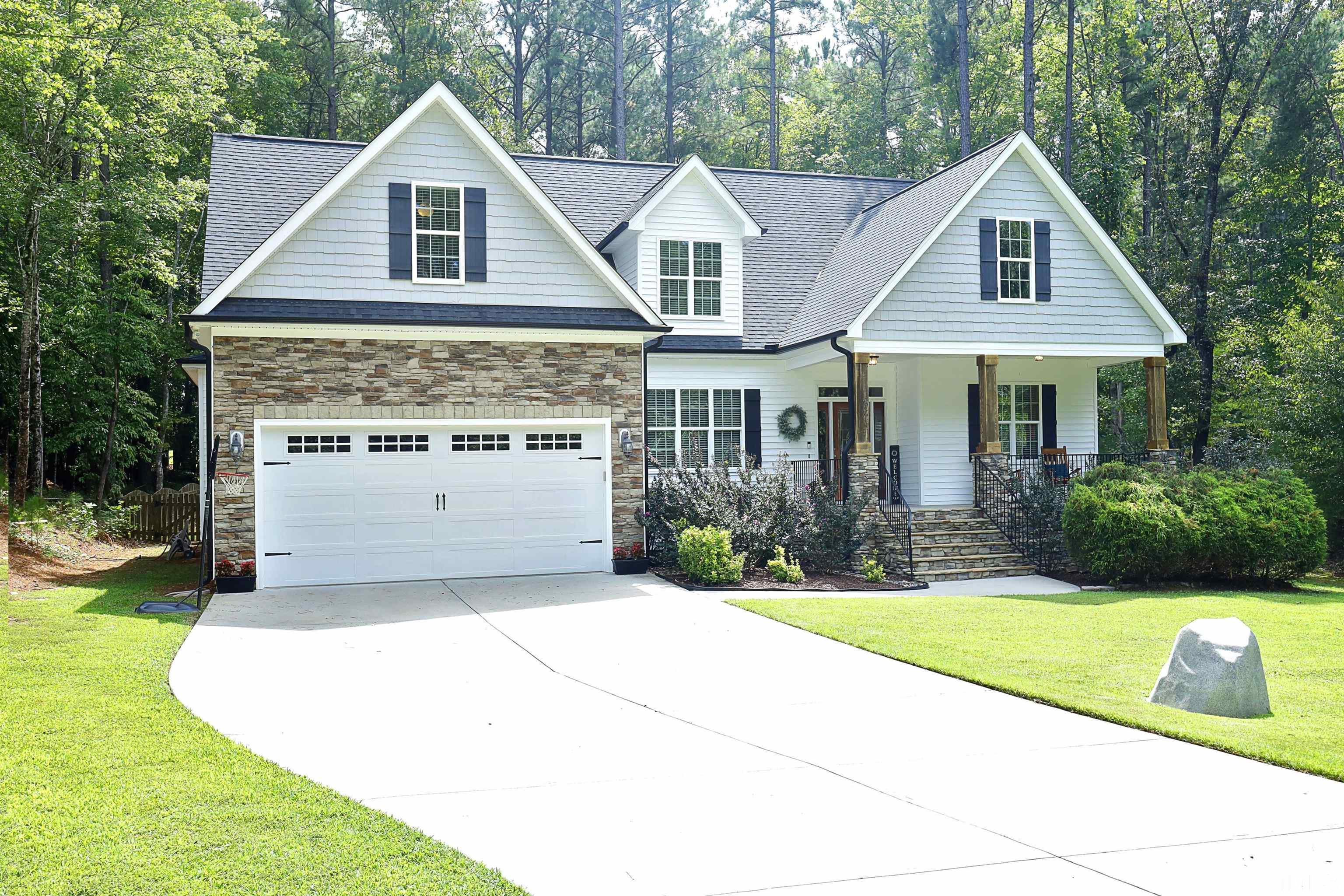 3630 Pine Needles Drive Wake Forest, NC 27587 - Photo 2 of 47 a front view of a house with yard and green space