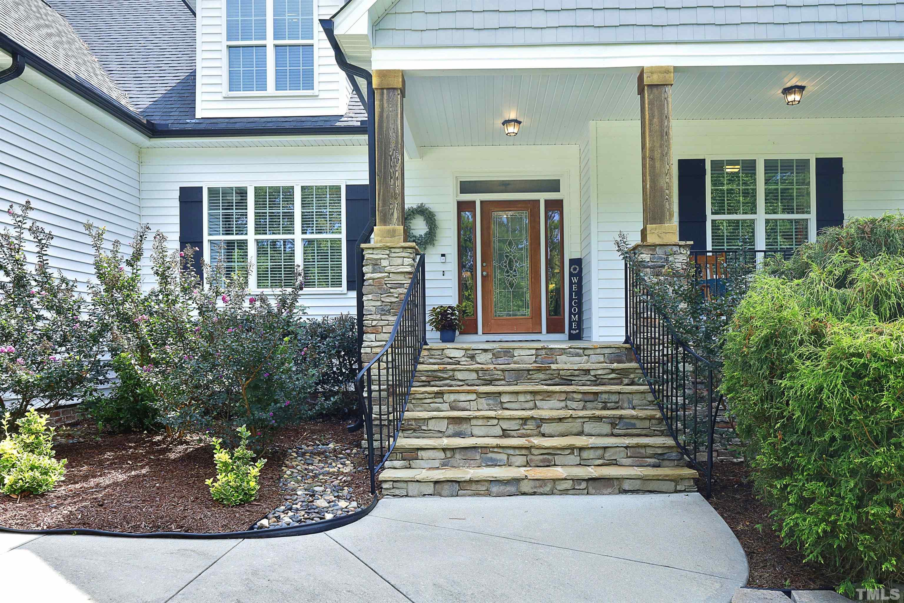 3630 Pine Needles Drive Wake Forest, NC 27587 - Photo 3 of 47 a front view of a house with plants